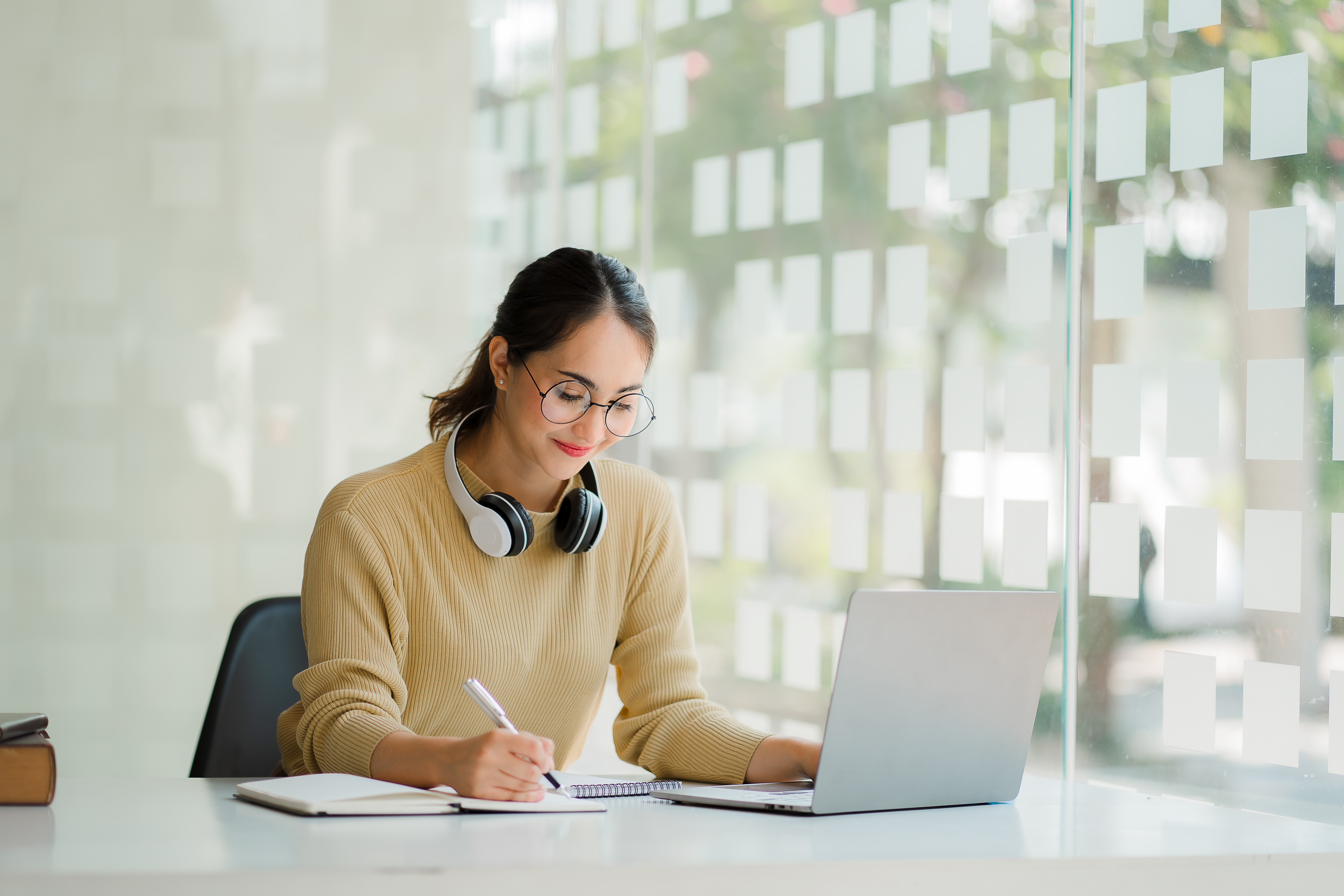 Woman With Headphones Working On Laptop